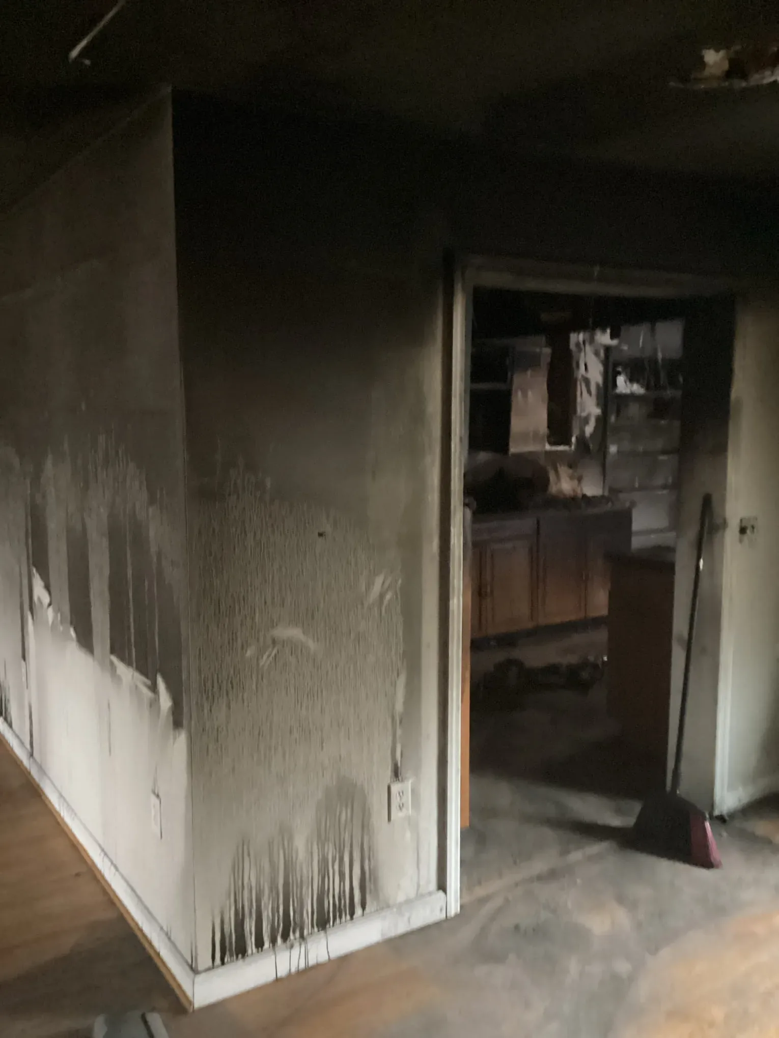 Interior wall blackened with soot, with a clean line showing where cleaning has already reached